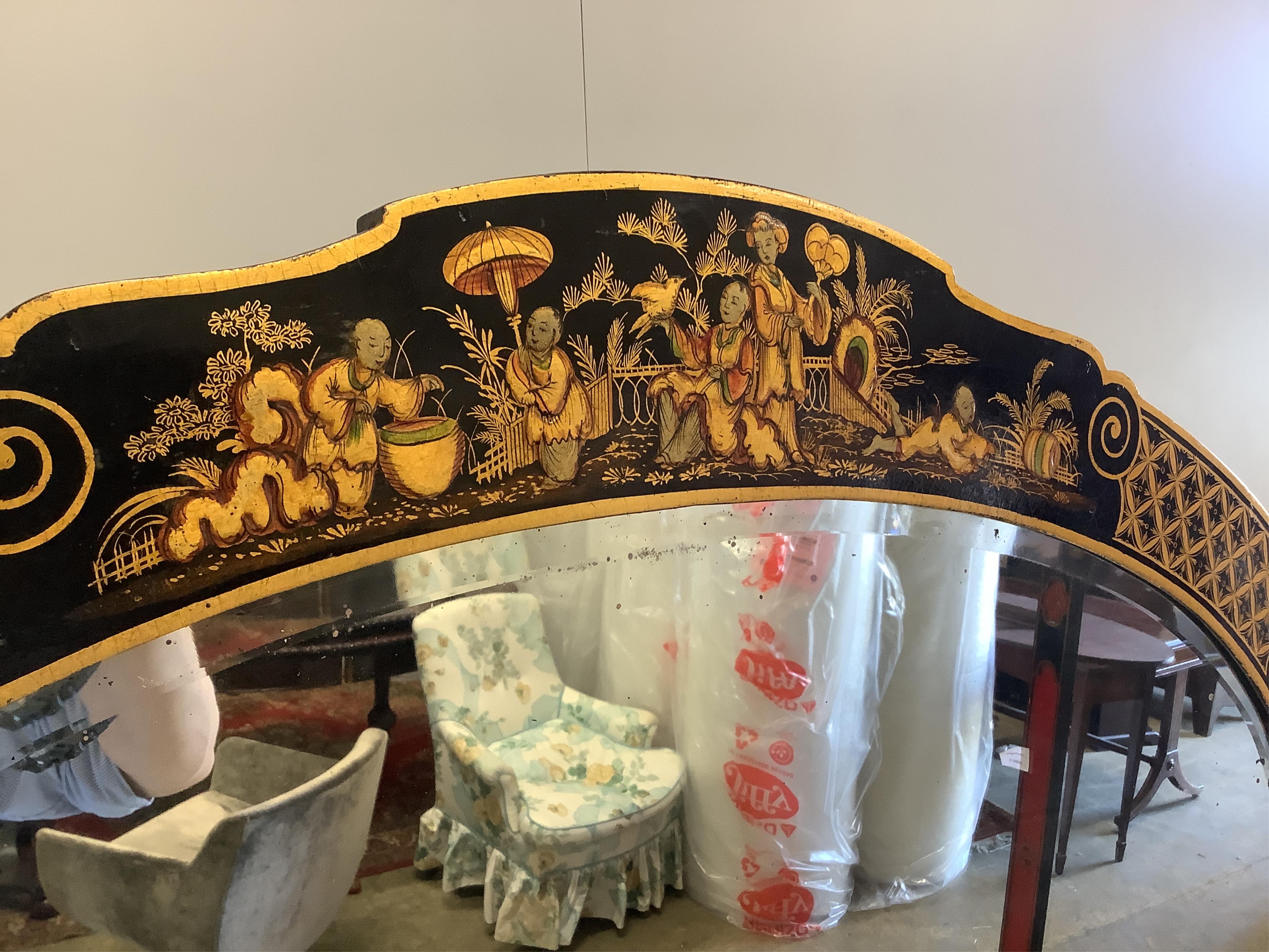 An early 20th century chinoiserie lacquer oval wall mirror, width 98cm, height 68cm. Condition - good